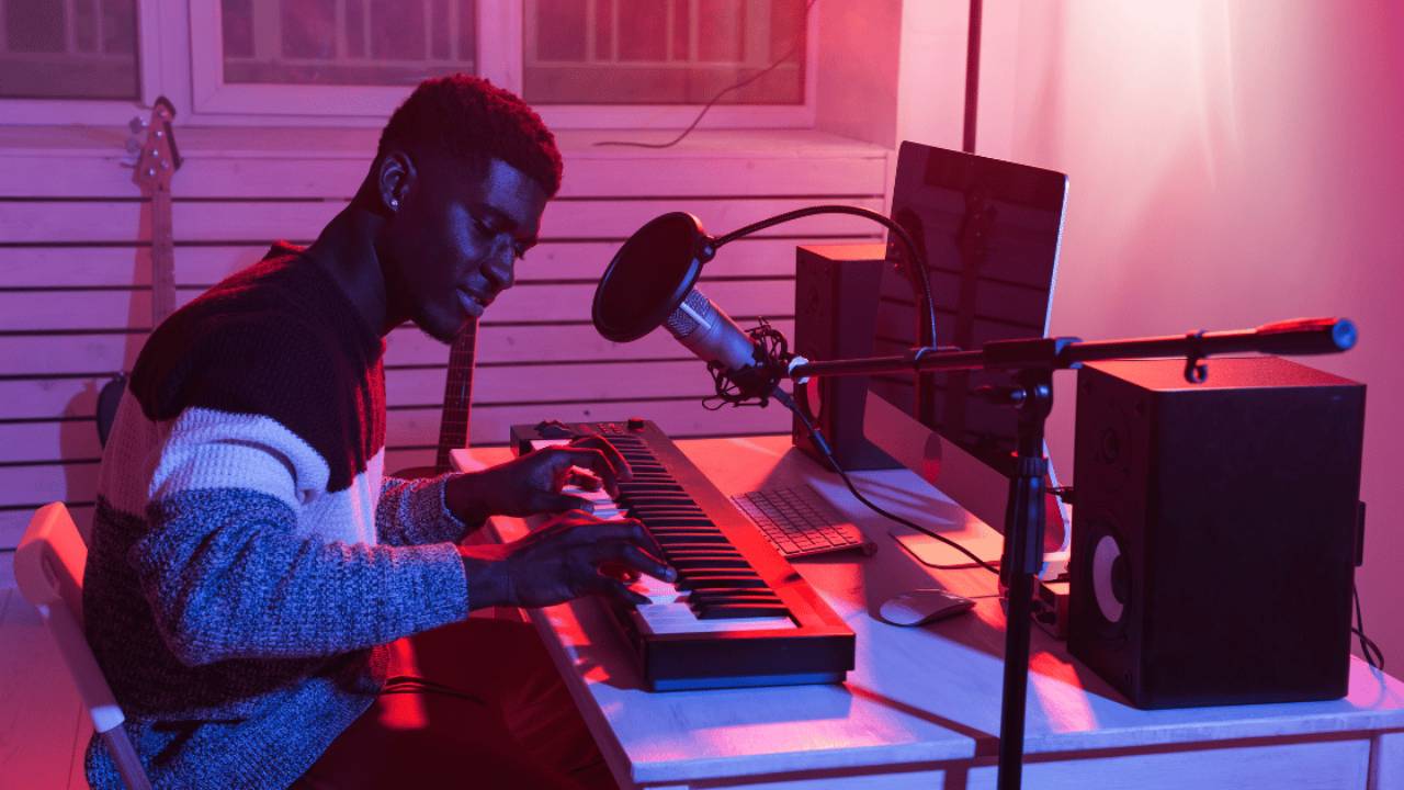 A music producer works on a song using a DAW