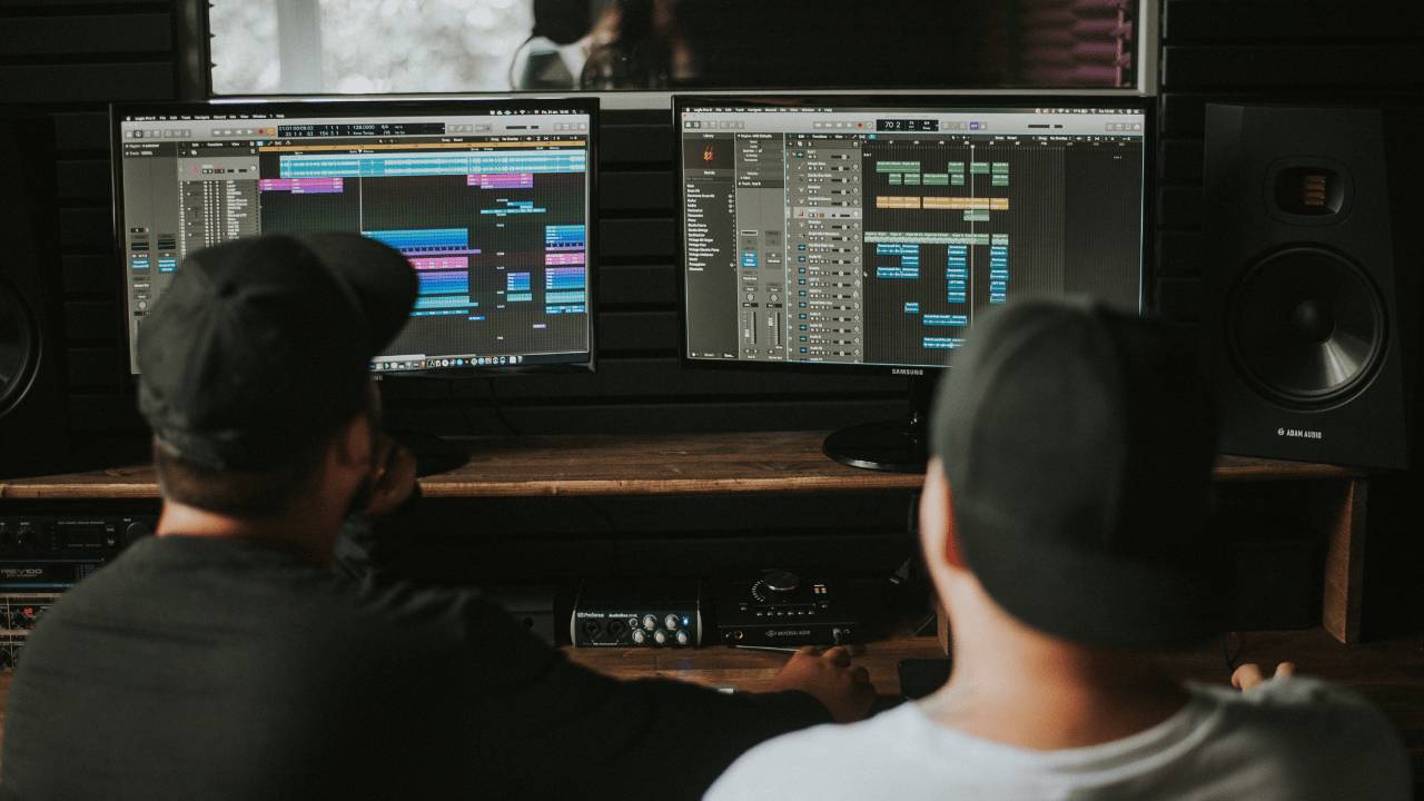 Two music producers record, edit and mix music with a DAW