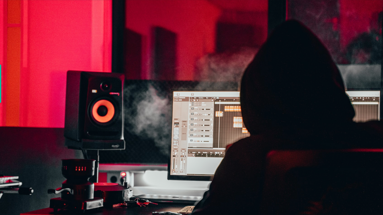 A beatmaker listens to mixes on a daw in a home studio
