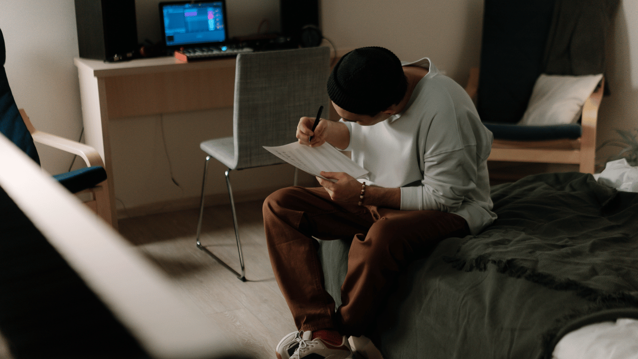 a beatmaker songwriter practices writing chorus lyrics for a new song