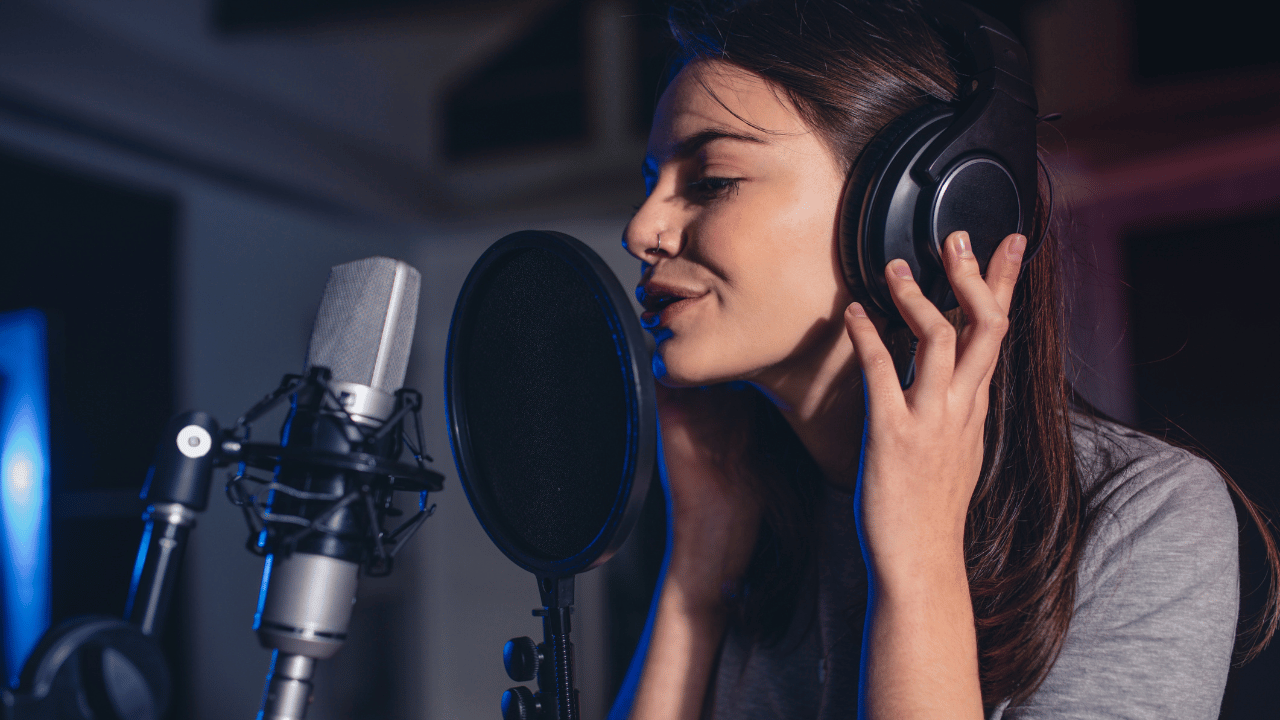 Singer recording vocals with a microphone and headphones into a DAW